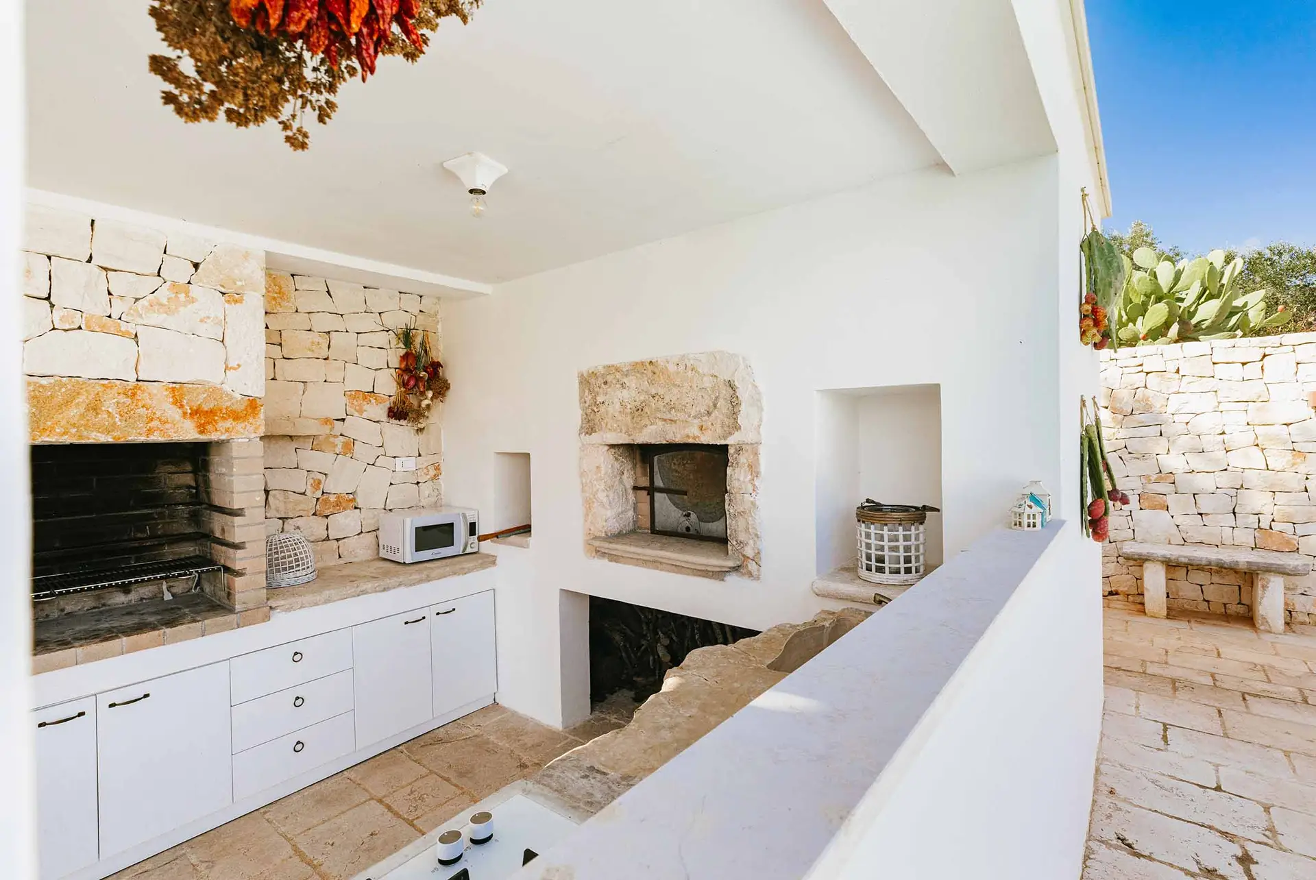 Cucina esterna attrezzata con barbecue e forno a legna